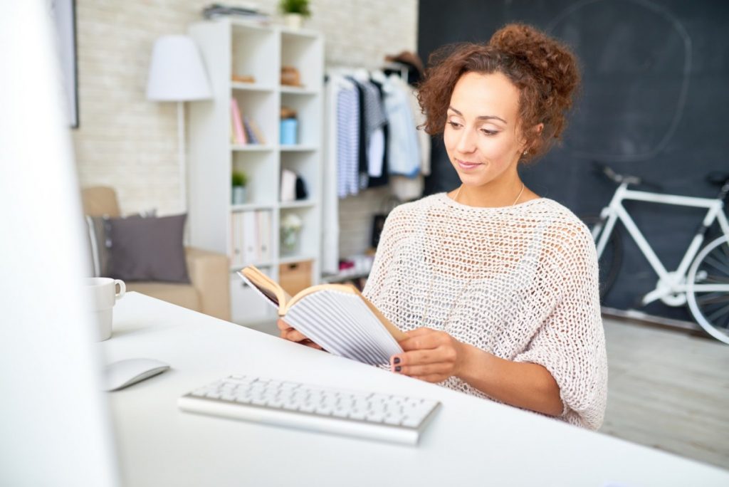 Mixed-Race Woman Relaxing at Desk in Home Office