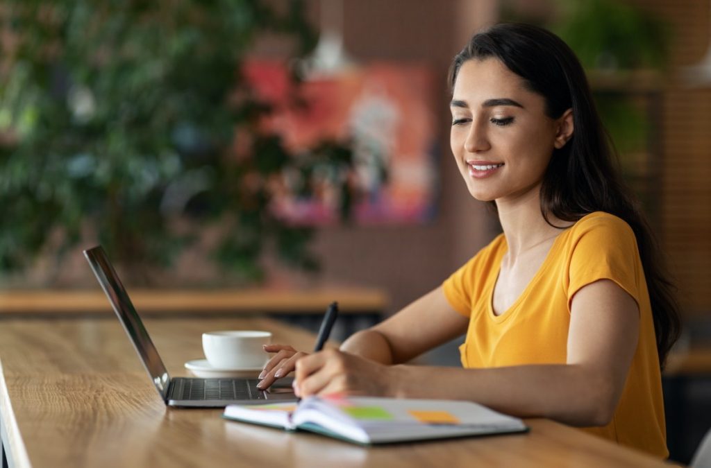 Young business woman planning her day, cafe interior