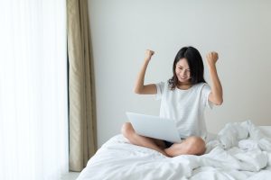 Excited Woman use of laptop computer