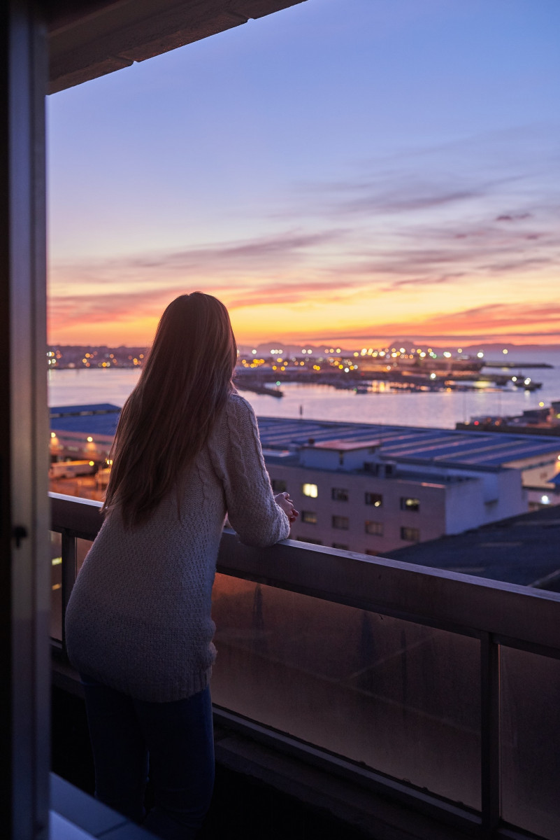 Young woman contemplating the sea from a balcony Young woman contemplating the sea from a balcony