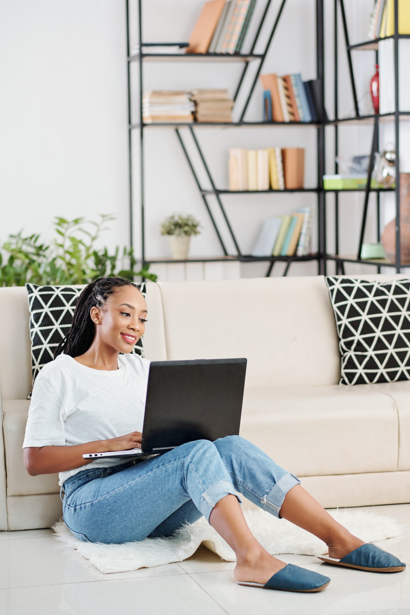 Woman coding on laptop at home